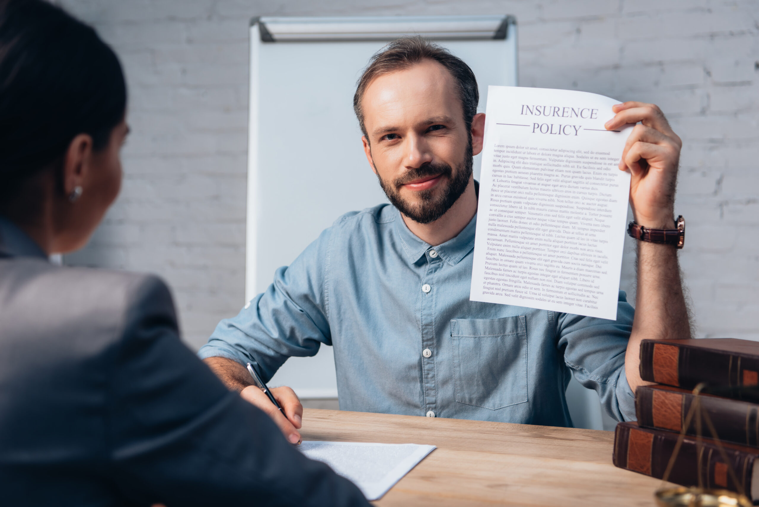 man holding an Insurance Policy in his hand